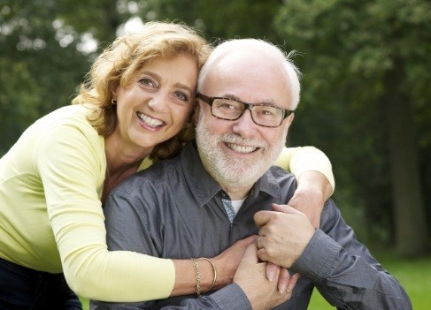 Older couple smiling after visiting their Anaheim California dentist