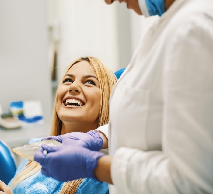 Woman smiling at dentist in state of the art dental office
