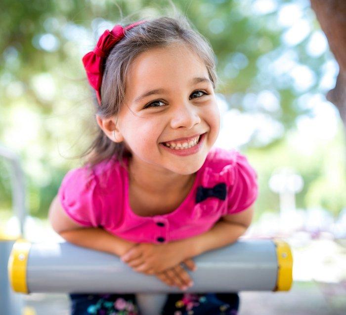 Child smiling after visiting her children's dentist