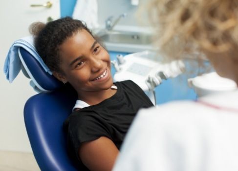 Child smiling at dentist after frenectomy for lip and tongue tie