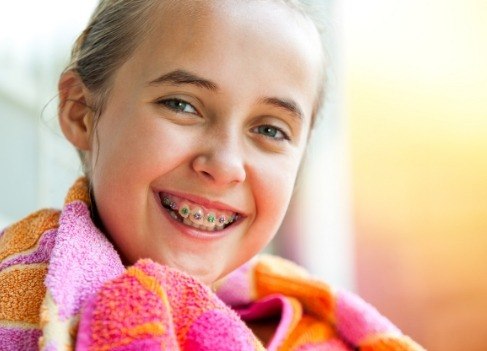 Young woman with traditional braces smiling