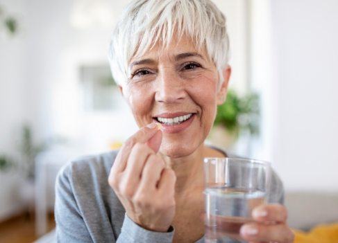 Woman taking oral conscious sedation dentistry pill