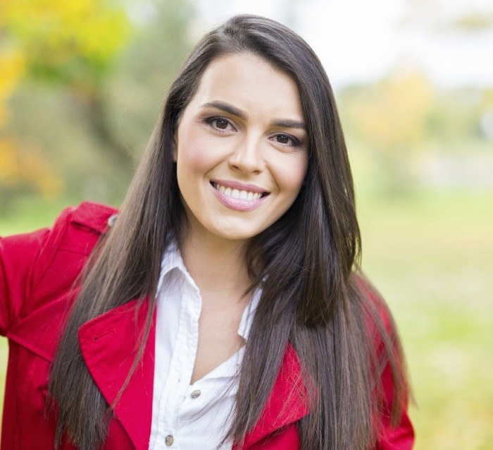 Woman sharing healthy smile thanks to dental services in Anaheim