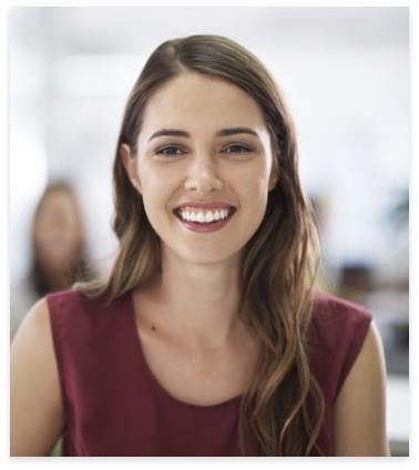 Woman sharing straight smile thanks to orthodontics