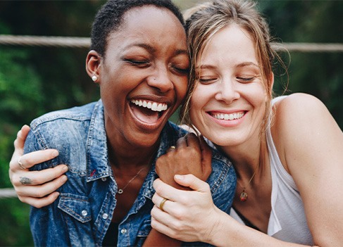 Veneers patient smiling with a friend