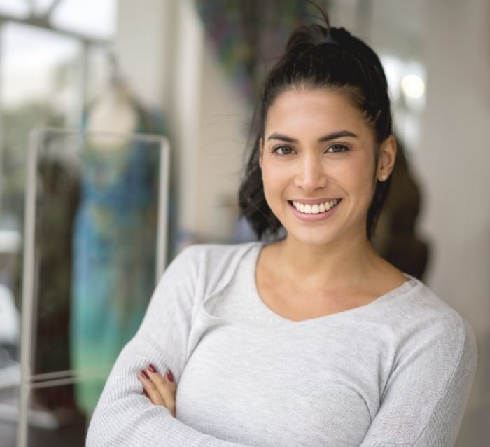 Young woman smiling after wisdom tooth extractions