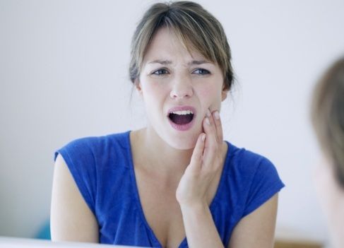 Woman in pain before wisdom tooth extraction